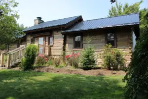 A log cabin home that has been repaired and restored